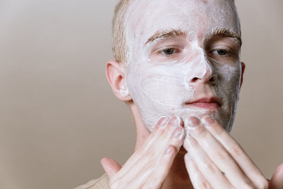 Close-up of a man applying facial cleanser for a refreshing skincare routine